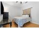 Cozy bedroom with neutral paint and curtains, wood flooring, and ample natural light at 4545 W Agate Ave, Las Vegas, NV 89139