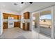 Well-lit kitchen featuring wooden cabinets, granite counters, and a sliding glass door to the backyard at 4545 W Agate Ave, Las Vegas, NV 89139