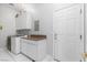 Functional laundry room with white cabinets, counter space, and a washer and dryer set at 4545 W Agate Ave, Las Vegas, NV 89139