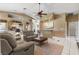 Open-concept living room with a ceiling fan, bar area, and neutral tones throughout at 4545 W Agate Ave, Las Vegas, NV 89139
