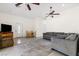 Inviting living room featuring neutral walls, tile floors, and a comfortable gray sectional sofa at 4545 W Agate Ave, Las Vegas, NV 89139