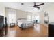 Spacious main bedroom featuring a fireplace, ceiling fan, and natural light from bay windows at 4545 W Agate Ave, Las Vegas, NV 89139