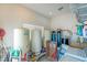 Bright utility room with water storage tanks, shelves, and appliances for optimal home maintenance at 4545 W Agate Ave, Las Vegas, NV 89139