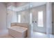 Modern bathroom with soaking tub, glass shower doors, and recessed lighting at 4750 Outlook Peak St, Las Vegas, NV 89135