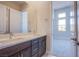 Bathroom features dual vanity and a view to the bedroom at 4750 Outlook Peak St, Las Vegas, NV 89135