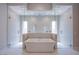 Luxurious bathroom featuring a soaking tub and glass-enclosed shower at 4750 Outlook Peak St, Las Vegas, NV 89135