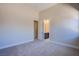 A spacious bedroom with neutral walls, plush carpet, and an ensuite bathroom at 4750 Outlook Peak St, Las Vegas, NV 89135