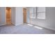 Bedroom with natural lighting, neutral carpet, closet and ensuite at 4750 Outlook Peak St, Las Vegas, NV 89135