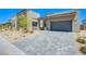 Beautiful exterior with a three-car garage and desert-friendly landscaping at 4750 Outlook Peak St, Las Vegas, NV 89135