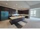 Modern kitchen featuring a large island, custom cabinetry, and stainless steel appliances at 4750 Outlook Peak St, Las Vegas, NV 89135