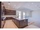 Gourmet kitchen with dark wood cabinets, quartz countertops, and stainless appliances at 4750 Outlook Peak St, Las Vegas, NV 89135