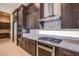 Modern kitchen featuring stainless steel appliances and dark wood cabinetry at 4750 Outlook Peak St, Las Vegas, NV 89135
