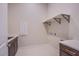 Functional laundry room featuring cabinets, shelving, and sleek countertops at 4750 Outlook Peak St, Las Vegas, NV 89135