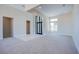 Bright living room featuring plush carpet, high ceilings, and clerestory windows at 4750 Outlook Peak St, Las Vegas, NV 89135
