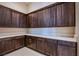 Well-organized pantry featuring dark wood cabinets and a white countertop for efficient storage at 4750 Outlook Peak St, Las Vegas, NV 89135