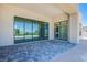 A spacious patio with stone pavers and large windows, perfect for outdoor relaxation at 4750 Outlook Peak St, Las Vegas, NV 89135