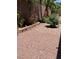 An outdoor space features a rock landscape design with trees and various plants at 495 Edgefield Ridge Pl, Henderson, NV 89012