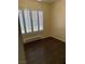 A bedroom showcasing wood floors and a window with stylish shutters at 495 Edgefield Ridge Pl, Henderson, NV 89012