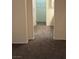Hallway view leading to a closet and bathroom, showcasing neutral-toned carpeting at 495 Edgefield Ridge Pl, Henderson, NV 89012