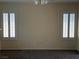 A spacious living room illuminated by two windows with plantation shutters at 495 Edgefield Ridge Pl, Henderson, NV 89012