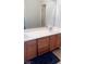 This bathroom has a double sink vanity, and is lit by a mirror with an accent light at 5004 Wayfaring Tree Ave, Las Vegas, NV 89131