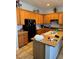 This kitchen has stainless steel appliances, light colored cabinets, tile floor, and a kitchen island at 5004 Wayfaring Tree Ave, Las Vegas, NV 89131