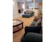 Inviting living space with dark couches, ottoman and clear sightlines at 5004 Wayfaring Tree Ave, Las Vegas, NV 89131