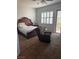 A well lit main bedroom with a slider to the backyard and a comfy chair at 5004 Wayfaring Tree Ave, Las Vegas, NV 89131