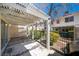 Outdoor patio with a pergola, iron fence and landscaped shrubs at 5256 Harvest Breeze Rd, Las Vegas, NV 89118