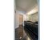 Bathroom featuring dual vessel sinks with a black countertop, dark cabinetry and modern fixtures at 5256 Harvest Breeze Rd, Las Vegas, NV 89118