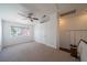 Bright bedroom with carpet floors, ceiling fan, window with a view, closet and a door at 5256 Harvest Breeze Rd, Las Vegas, NV 89118