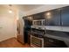 Well-equipped kitchen with stainless steel appliances, granite countertops, and adjacent dining area at 5256 Harvest Breeze Rd, Las Vegas, NV 89118