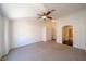 Spacious main bedroom with neutral carpeting, ceiling fan, and an ensuite bathroom and walk-in closet at 5256 Harvest Breeze Rd, Las Vegas, NV 89118