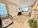 A bedroom with a dog crate has direct sunlight from the windows at 5368 Regal Ave, Las Vegas, NV 89146
