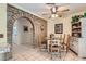Charming dining area with brick archway, features tiled flooring and wooden table, blending rustic charm with modern living at 5368 Regal Ave, Las Vegas, NV 89146