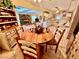 Cozy dining area showcasing a rustic wooden table and chairs, blending seamlessly with the adjacent kitchen and living room at 5368 Regal Ave, Las Vegas, NV 89146