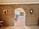 Hallway view through brick archway, highlighting the home's unique architectural details and transitional spaces at 5368 Regal Ave, Las Vegas, NV 89146