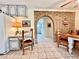 Bright kitchen features white cabinets and brick archway leading to other living spaces, complete with a retro style at 5368 Regal Ave, Las Vegas, NV 89146