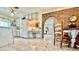 Bright kitchen features white cabinets and brick archway leading to other living spaces, complete with a retro style at 5368 Regal Ave, Las Vegas, NV 89146
