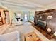 Inviting living room with a stone fireplace, wood beams, and access to the backyard pool at 5368 Regal Ave, Las Vegas, NV 89146