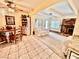 Open-concept living space with tiled flooring, offering seamless flow between living, dining, and fireplace area at 5368 Regal Ave, Las Vegas, NV 89146
