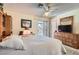 Bright main bedroom with a large bed, wooden furniture, and sliding door to the patio at 5368 Regal Ave, Las Vegas, NV 89146