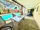 Charming covered patio area with poolside seating, decor and a tranquil lounge area, perfect for relaxation and enjoying outdoors at 5368 Regal Ave, Las Vegas, NV 89146