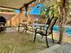Covered patio with seating, vintage nautical decor, and a pool view at 5368 Regal Ave, Las Vegas, NV 89146