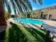 Beautiful backyard pool with mature landscaping and a covered patio featuring nautical decor at 5368 Regal Ave, Las Vegas, NV 89146