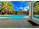 Sparkling backyard pool surrounded by mature palm trees and tropical landscaping at 5368 Regal Ave, Las Vegas, NV 89146