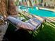 Lounge chair next to a backyard pool with artificial grass at 5368 Regal Ave, Las Vegas, NV 89146