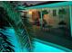 Covered outdoor patio with seating that overlooks a sparkling pool at 5368 Regal Ave, Las Vegas, NV 89146