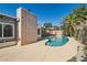 Backyard pool featuring a brick fireplace, pool surround, and covered patio at 5368 Regal Ave, Las Vegas, NV 89146