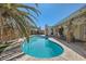 Inviting backyard pool with beautiful blue water, concrete surround, and a charming covered patio at 5368 Regal Ave, Las Vegas, NV 89146
